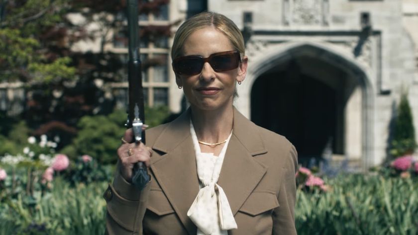 Sarah Michelle Gellar smiling with a gun at the Ready Or Not 2 trailer. 
