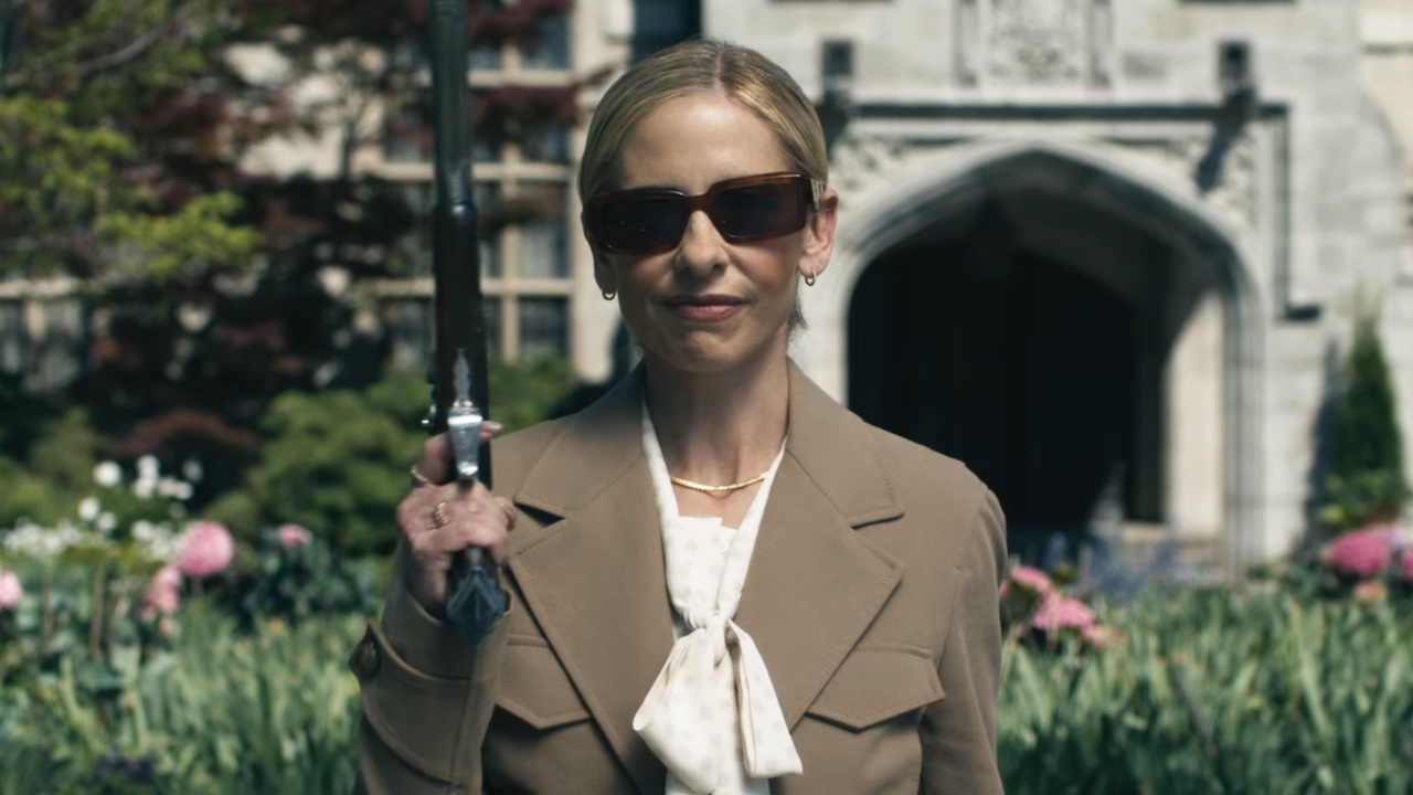 Sarah Michelle Gellar smiling with a gun at the Ready Or Not 2 trailer. 