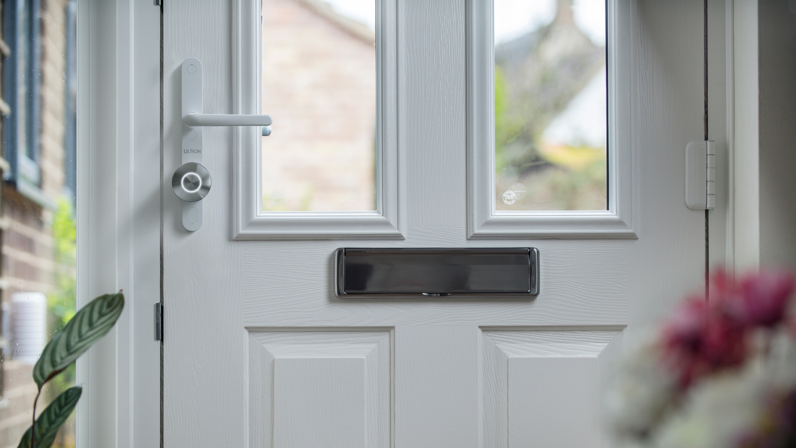 Ultion smart lock on white UPVC door in hallway