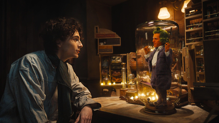 Timothée Chalamet as Willy Wonka and Hugh Grant as an Oompa-Loompa pictured in the trailer of the upcoming Wonka film