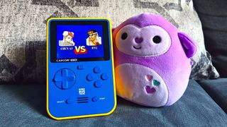 Super Pocker Capcom Edition with Street Fighter 2 on screen featuring Chung Li vs Ryu graphic and Valentines Day Squishmallow monkey on right hand side.