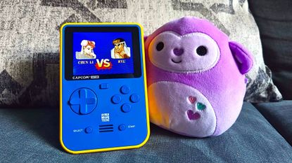 Super Pocker Capcom Edition with Street Fighter 2 on screen featuring Chung Li vs Ryu graphic and Valentines Day Squishmallow monkey on right hand side.