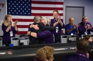 Cassini project manager Earl Maize (left) and spacecraft operations team manager Julie Webster embrace after the Cassini spacecraft plunged into Saturn, Friday, Sept. 15, 2017 at NASA's Jet Propulsion Laboratory in Pasadena, California.