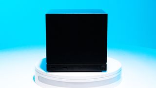 The Steam Machine on a white stand with a blue background and various ports on display.