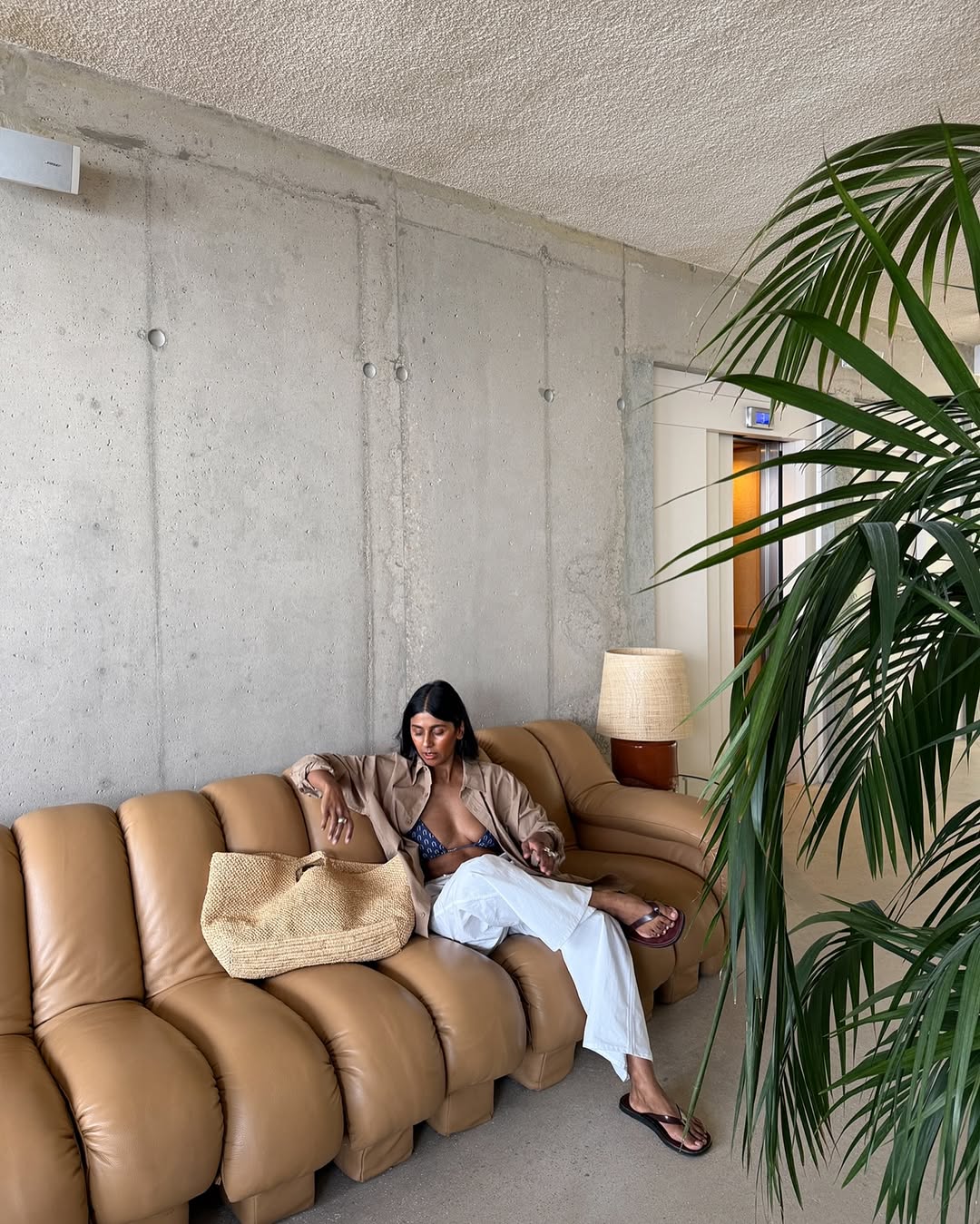 @monikh wearing big raffia tote