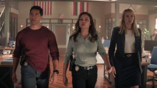 (L-R): Alex Tarrant as Kai Holman, Vanessa Lachey as Jane Tennant, and Tori Anderson as Kate Whistler walking down a hall in NCIS: Hawai'i.
