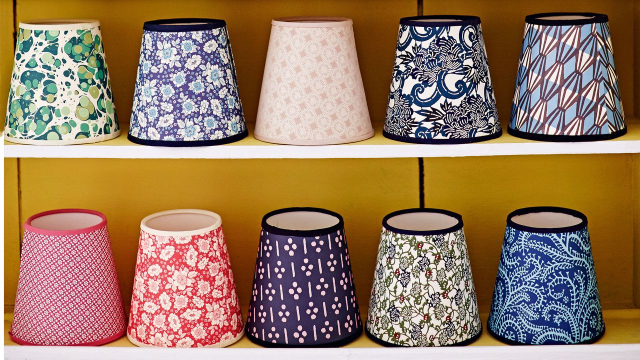 Floral fabric lampshades lined up on shelves