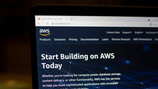 The AWS website displayed on a laptop in the dark