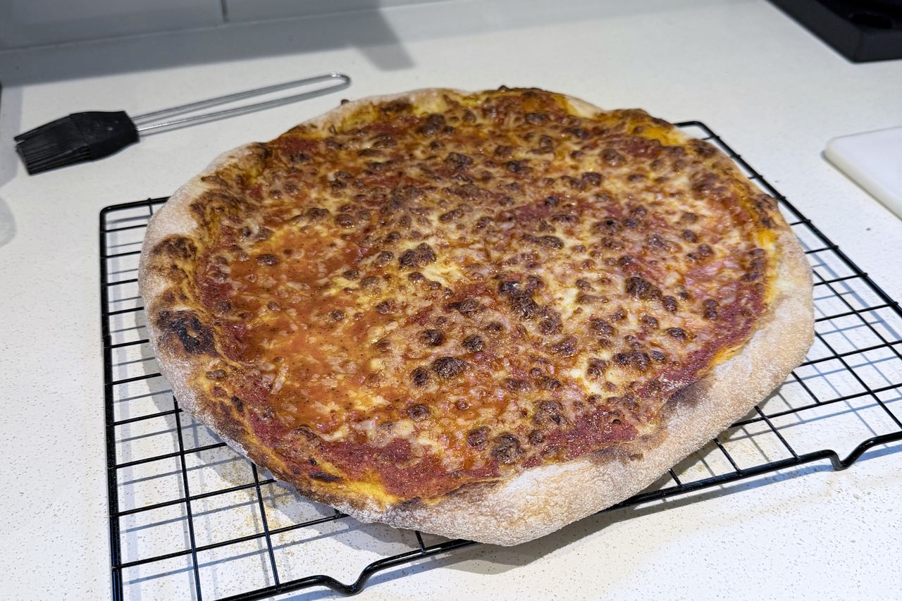 A pizza cooling on a counter