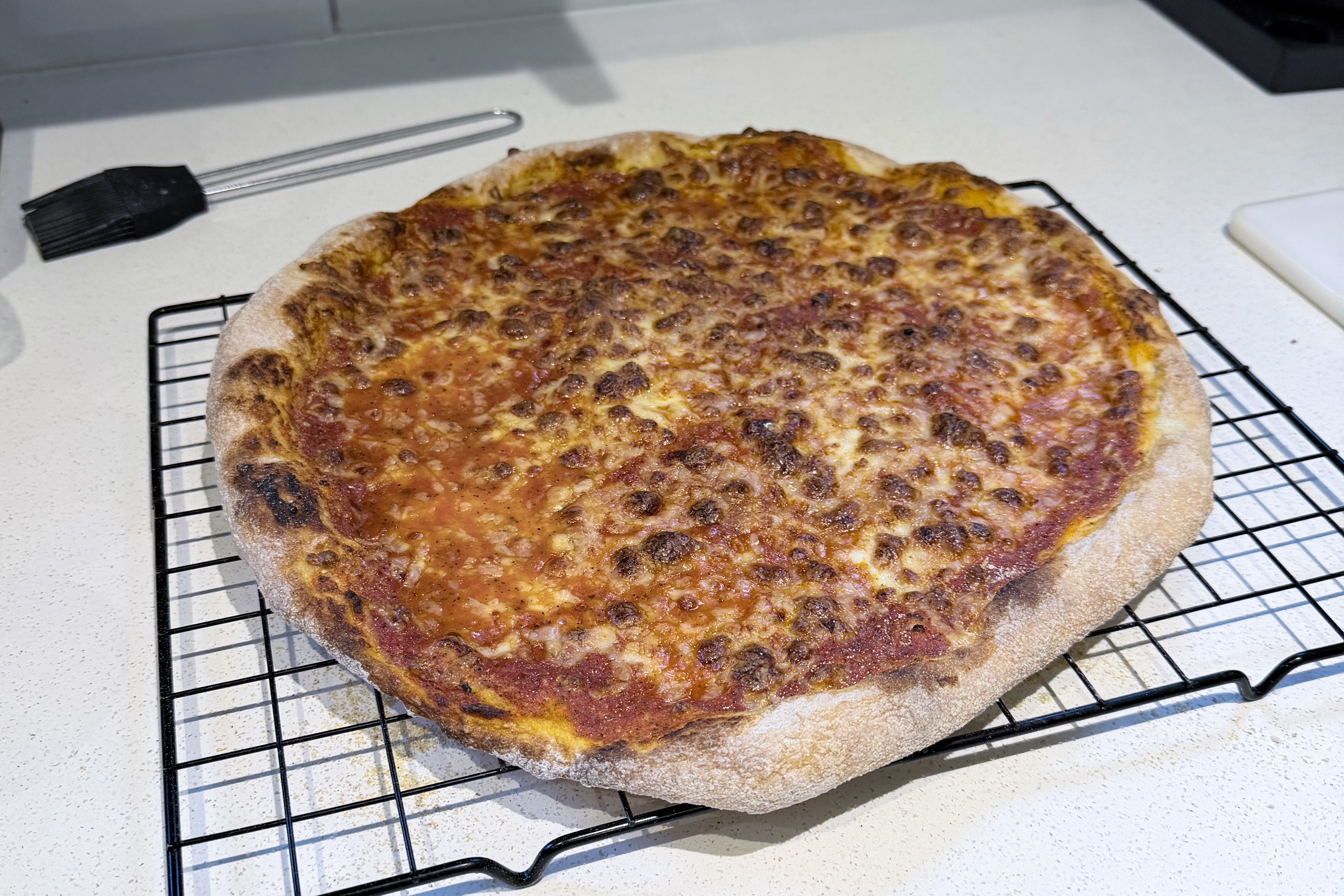 A pizza cooling on a counter