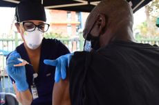 A nurse administers the Johnson & Johnson COVID-19 vaccine to a man at a community outreach event in Los Angeles on Aug. 22, 2021.