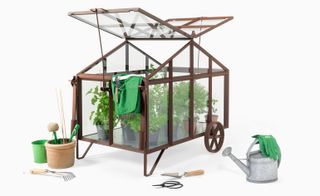 Glass greenhouse with wheels and its roof raised