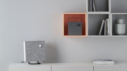Bluetooth speaker on storage unit in living room
