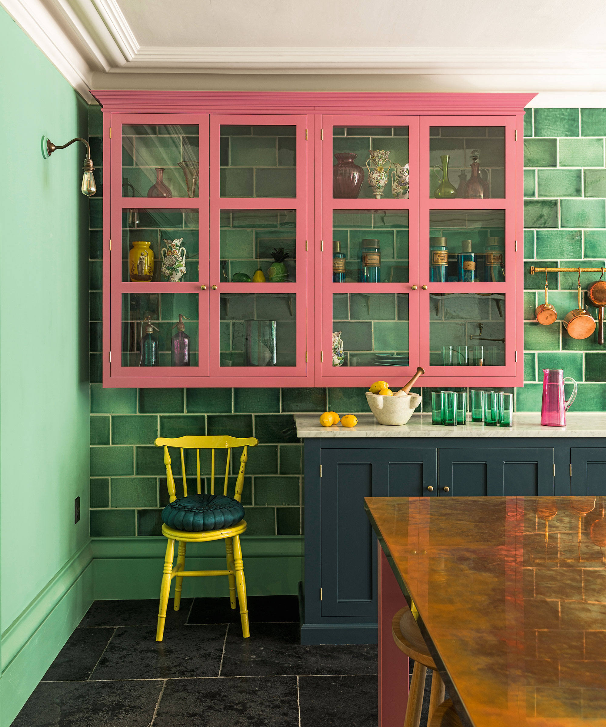 Pink and navy kitchen with green tiles and walls by DeVOL