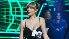 Taylor Swift accepts an award onstage
