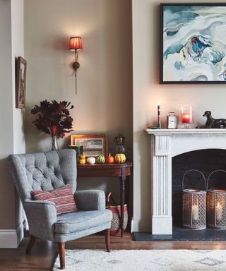 Living room styled for autumn with lanterns in the fireplace