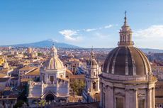 Domes around Sant'Agata cathedral in central Catania with Mount Etna in the background to the north.