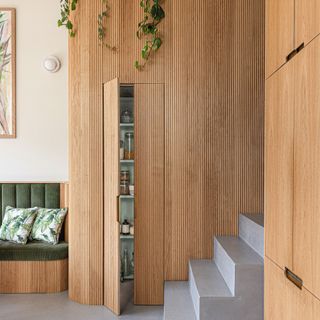 hidden larder with ridged wood covering next to stairs
