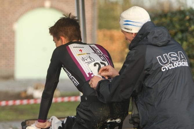 Geoff Proctor pins on Austin Vincent's number at GP Sven Nys.