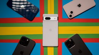 Google Pixel 7a next to iPhones