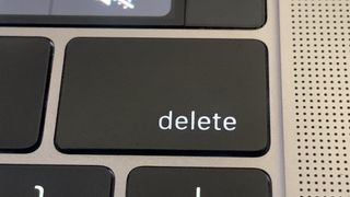 A close-up of a Delete key on a Macbook Pro