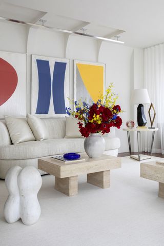 White living room with mid-century modern art