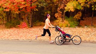 Woman with running stroller in park