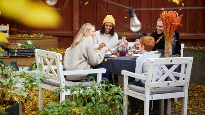 Smiling family and friends sitting at table for social gathering