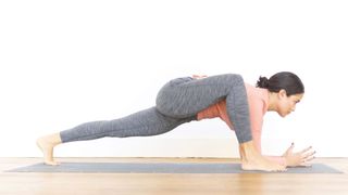 a photo of a woman doing the lizard pose