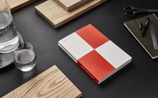 White and red checked book on desk