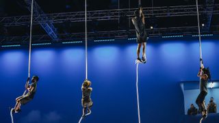 Contestants climbing ropes during the Wings of Icarus challenge in Physical: 100