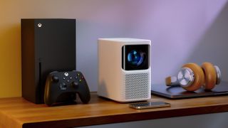 The Emotn N1 next to an Xbox Series X which is bigger than it