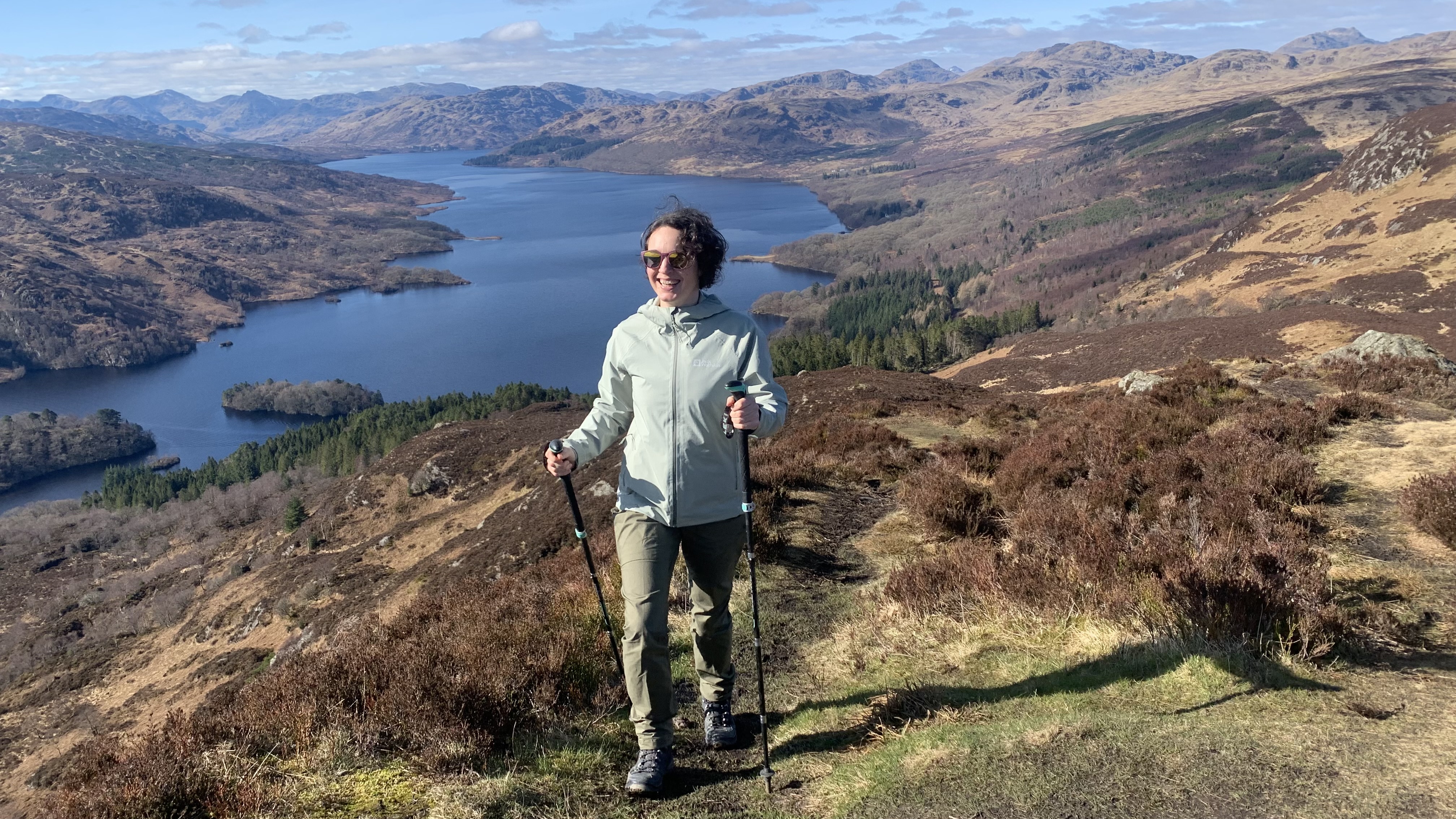 Julia Clarke hiking with Loch Katrine in the background