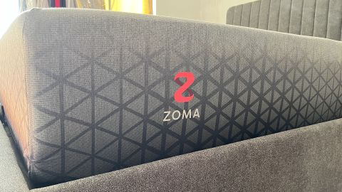 Zoma Hybrid mattress photographed from the side in reviewer's bedroom