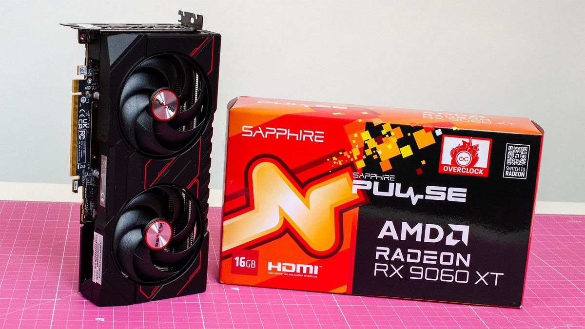 An AMD Radeon RX 9060 XT next to its retail packaging on a table