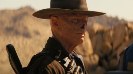 Walton Goggins as The Ghoul looking seriously at Lucy.