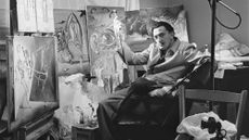 Salvador Dalí sits in his New York studio surrounded by his paintings in 1943