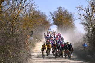 SIENA ITALY MARCH 05 A general view of the peloton passing through gravel roads landscape during the Eroica 8th Strade Bianche 2022 Womens Elite a 136km one day race from Siena to Siena Piazza del Campo 321m StradeBianche on March 05 2022 in Siena Italy Photo by Luc ClaessenGetty Images