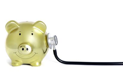 A piggy bank with a stethoscope 