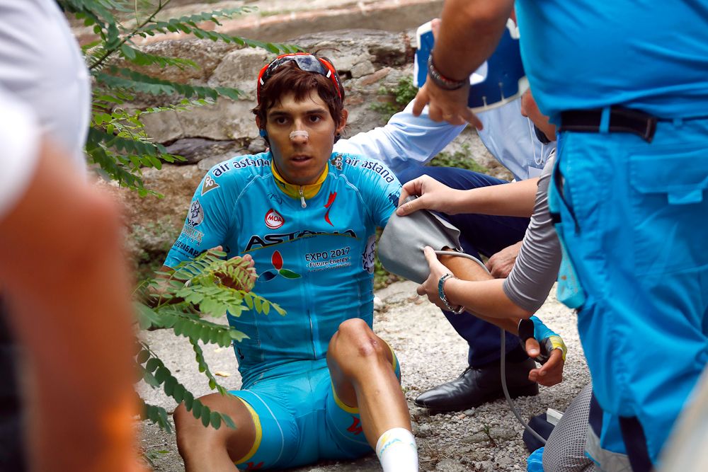 Medics attend Diego Rosa (Astana) after crashing at Giro della Toscana