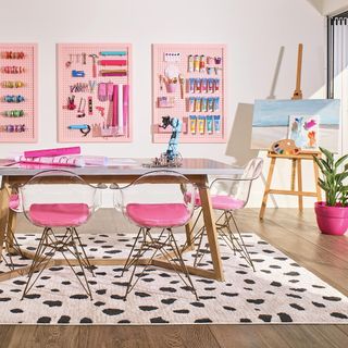 hobby room with pink chair and floorboard