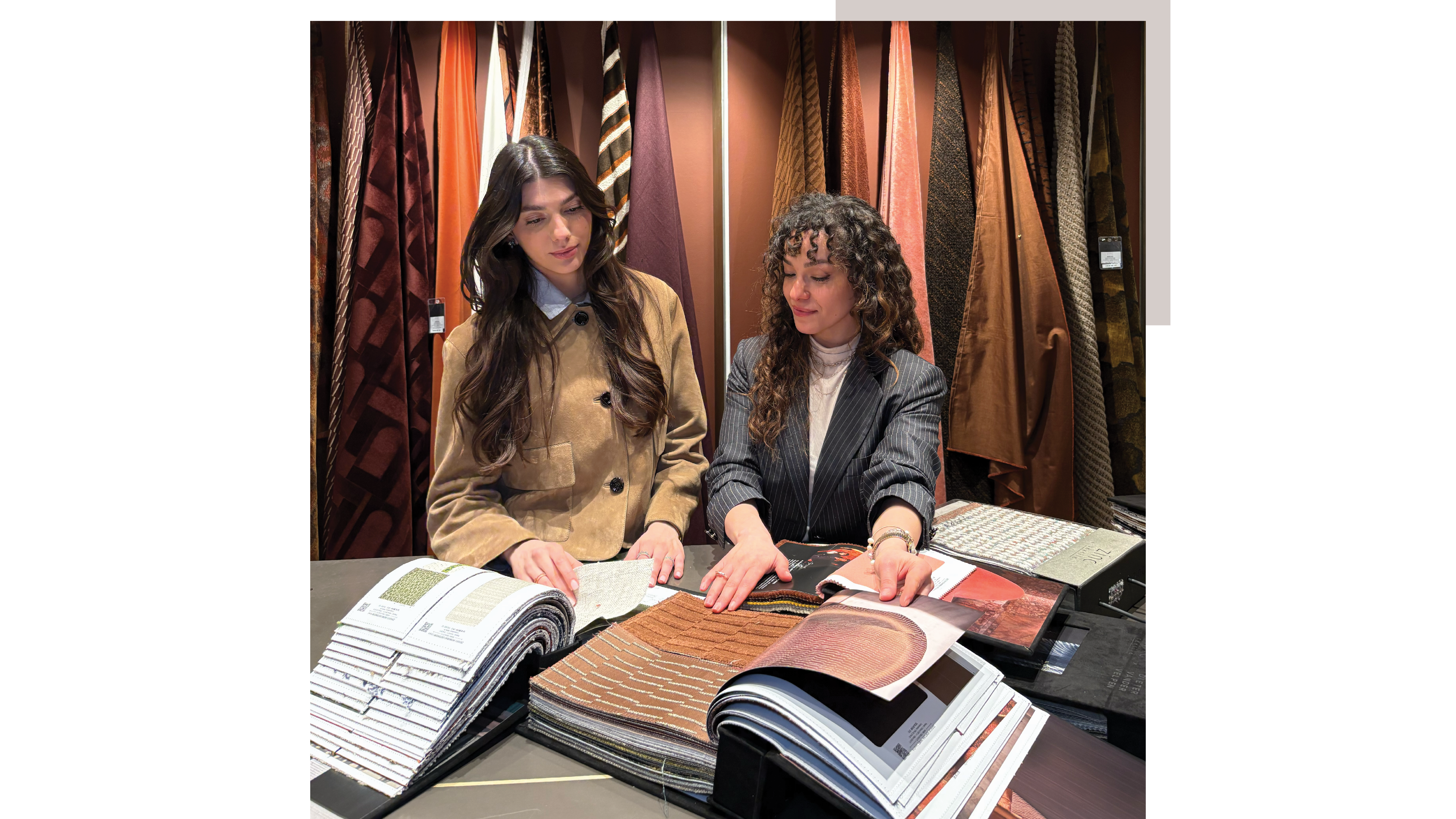 Iokasti Sotirakopoulou and Miaad Latoof, Design Lab by Livingetc stylists, looking at a sample book in a fabric showroom