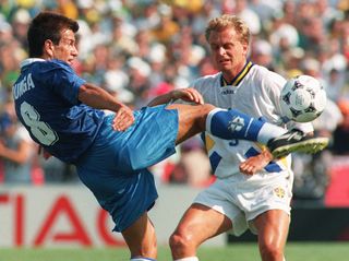 Brazil's Dunga kicks the ball away from Sweden's Jonas Thern at the 1994 World Cup.