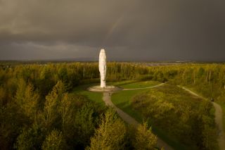 "Dream" by Jaume Plensa is surrounded by Autumnal trees on October 26, 2020 in St Helens, United Kingdom