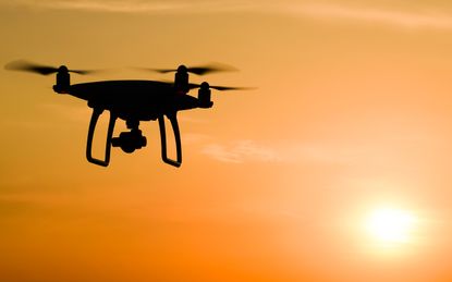 A drone flying at sunset