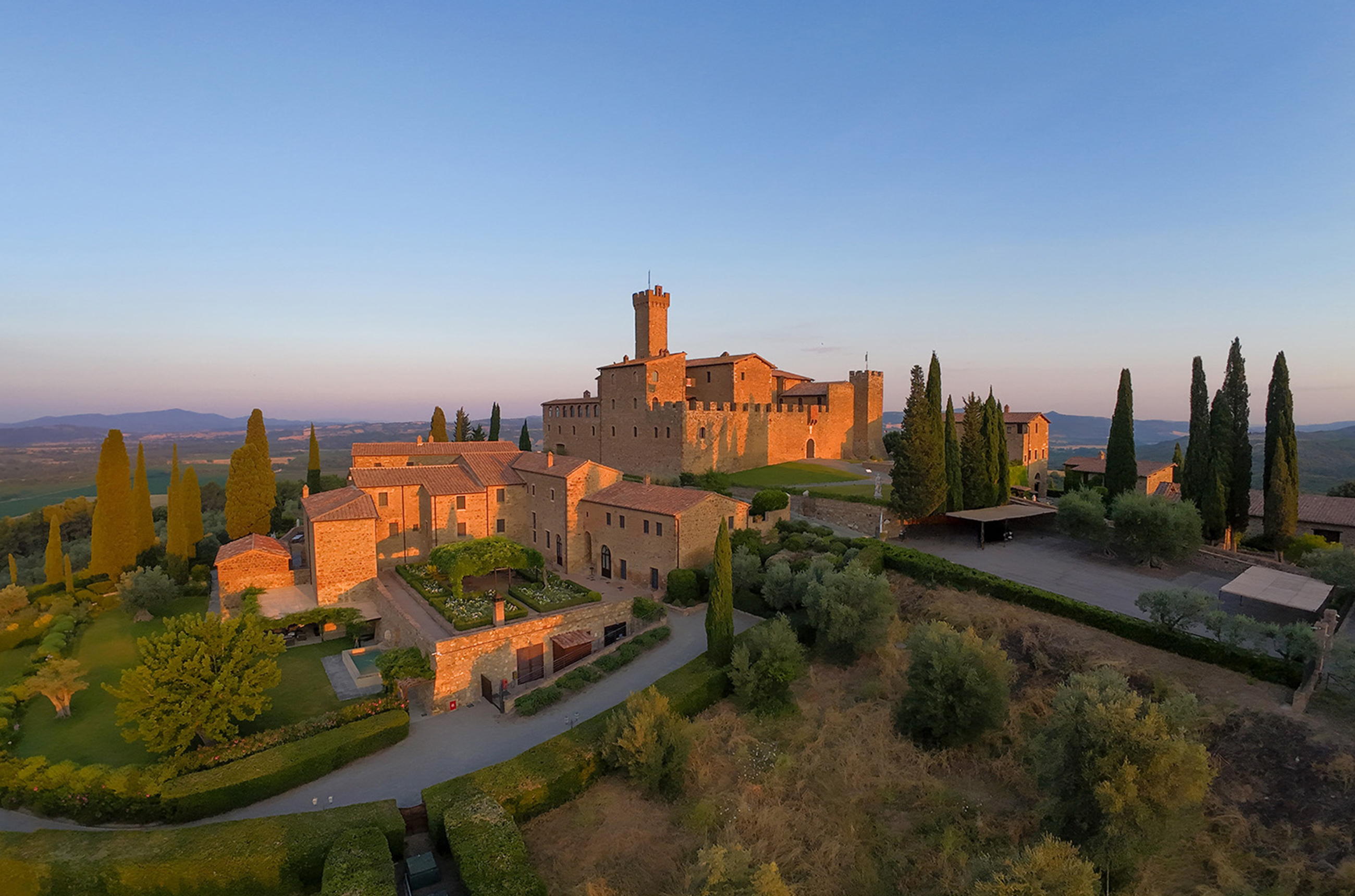 Large castle on a green hill at sunset