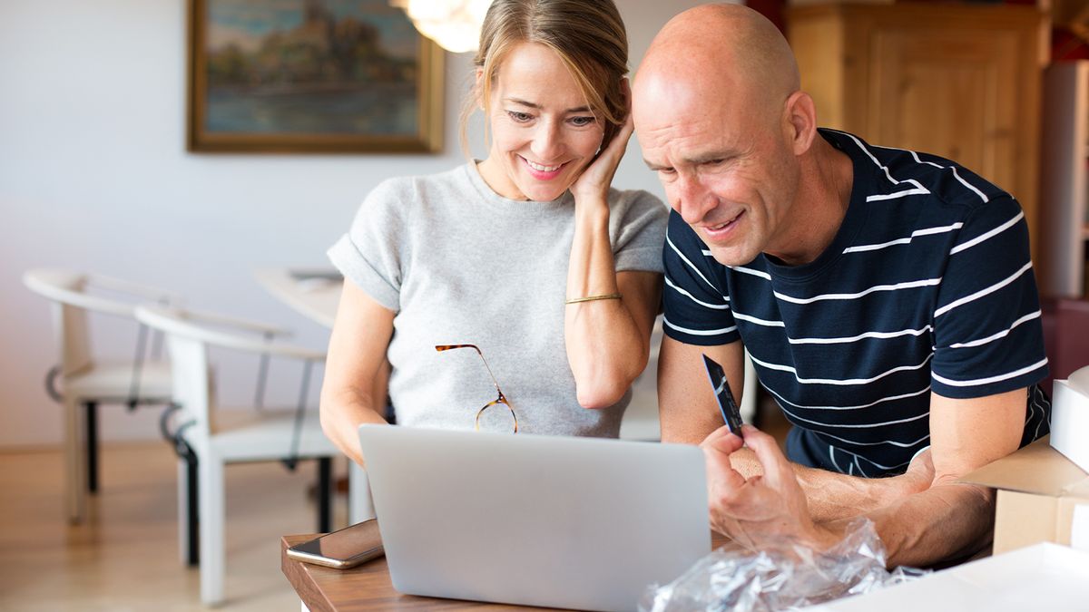 A couple opens a new laptop