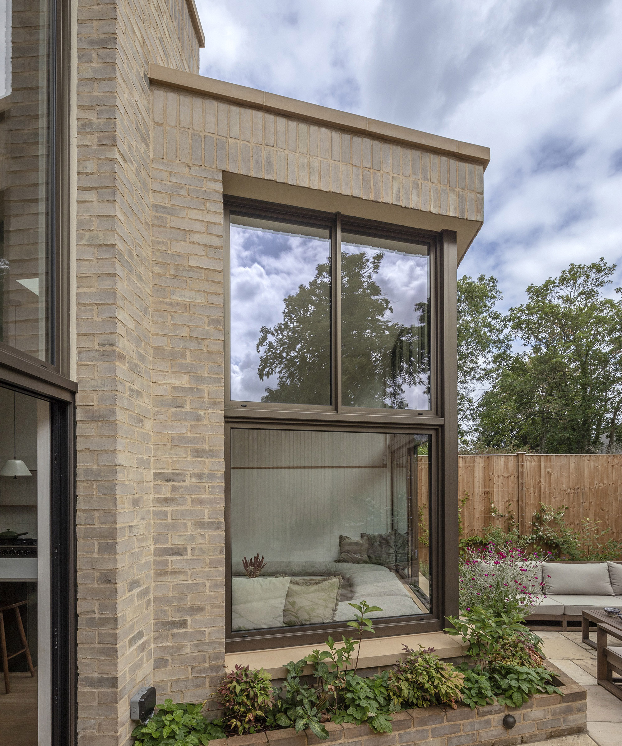 A rear kitchen extension with double height glazing and brick clad exterior