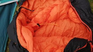 Vango Cobra 600 sleeping bag on some grass next to a tent