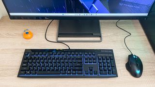 Acer Predator Orion 7000 (2023) on desk with keyboard and mouse